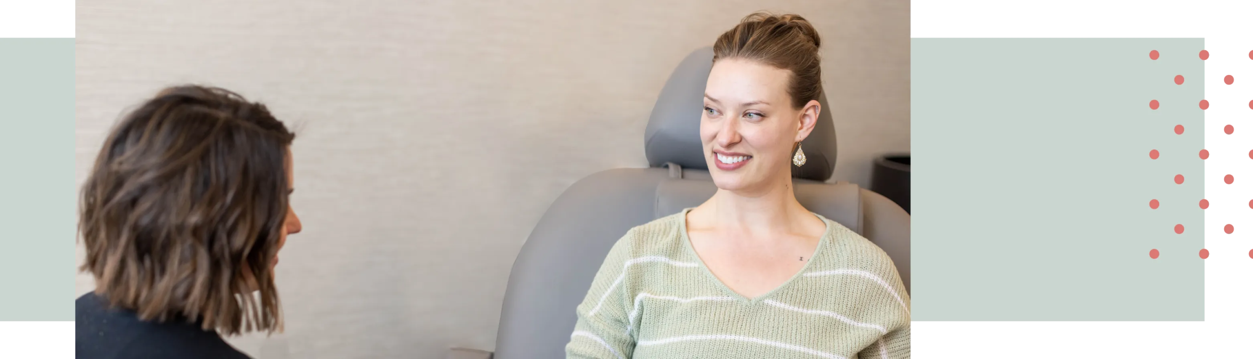 A Kalon client smiles at a provider. Both are seated and in conversation.